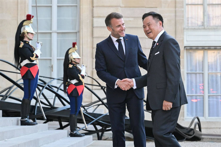 マクロン大統領（左）と握手するアヌティン首相